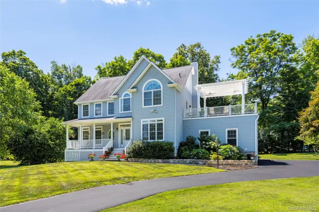 a view of a house with swimming pool and a yard
