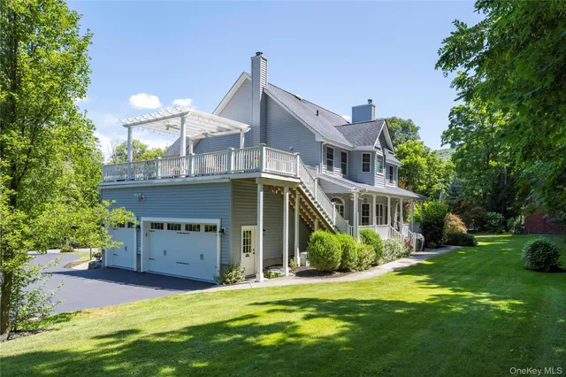 a kitchen with stainless steel appliances granite countertop a kitchen island a stove a refrigerator a dining table and chairs with wooden floor