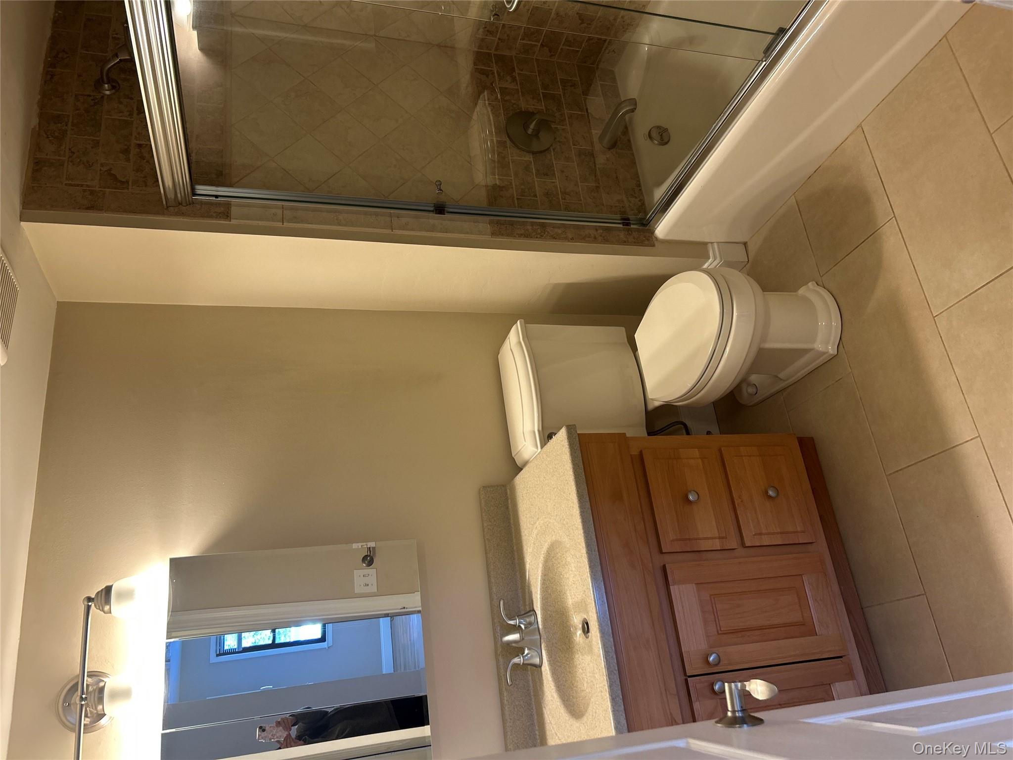 135 West Nyack Road, Unit 111 Nanuet, NY 10954 - Photo 12 of 16 Bathroom with vanity, combined bath / shower with glass door, and light tile patterned flooring