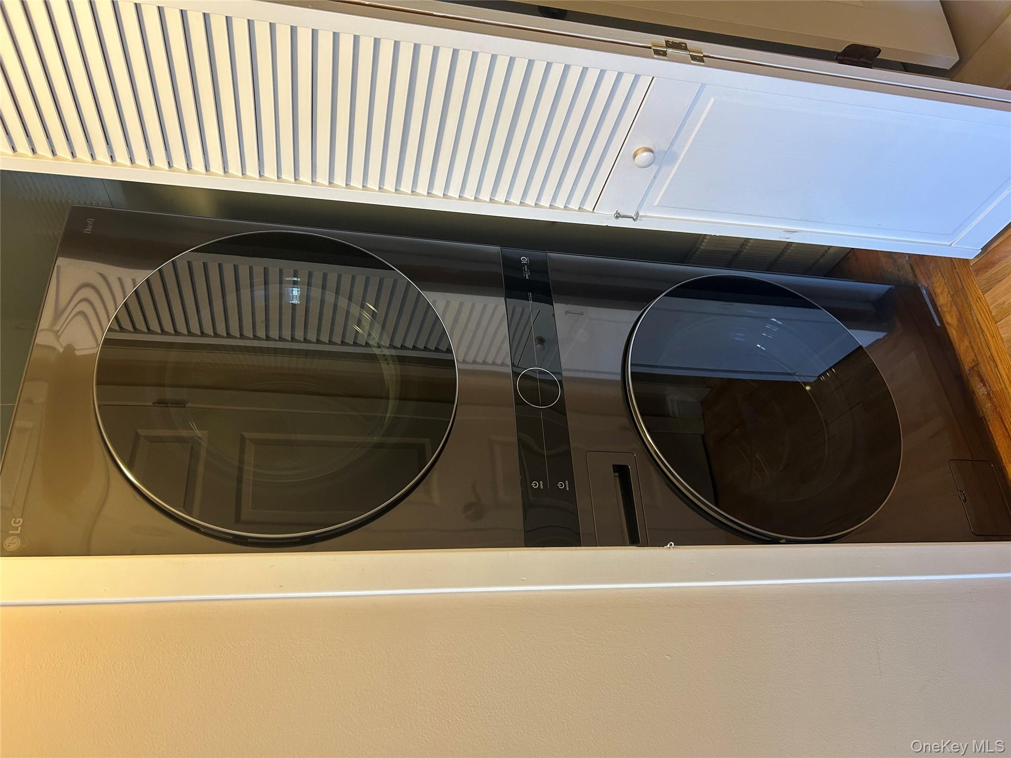 135 West Nyack Road, Unit 111 Nanuet, NY 10954 - Photo 13 of 16 Laundry area with light wood-style floors and stacked washer / dryer