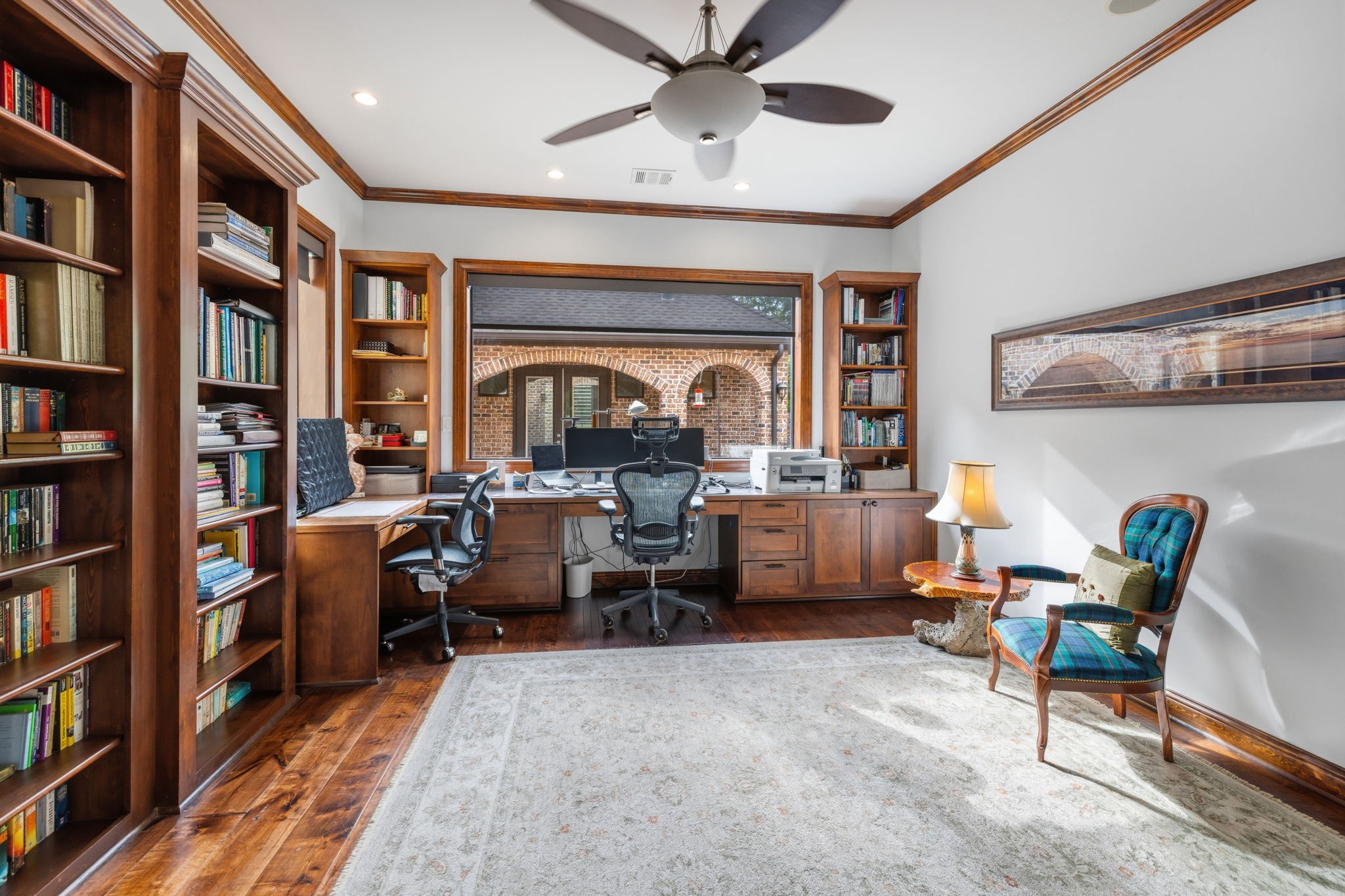6918 Comanche Bend Montgomery, TX 77316 - Photo 40 of 50 Study, office, library, nursery, playroom, or homework station for the kiddos, this flexible space overlooks the front courtyard and features custom shelving and beautiful built-ins, creating a warm and functional room designed to fit a variety of lifestyle needs.