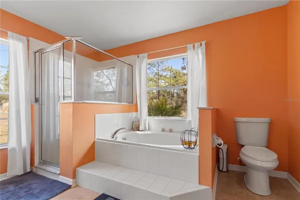 a bathroom with a toilet a sink and a large mirror