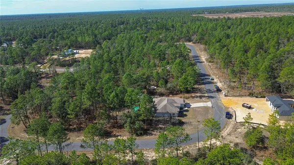 an aerial view of a house with yard