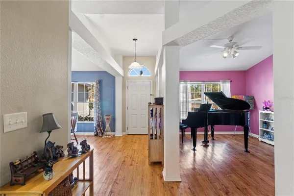 a view of a livingroom with furniture a dinning room and wooden floor