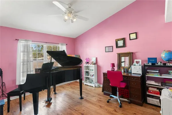 a livingroom with furniture and a piano