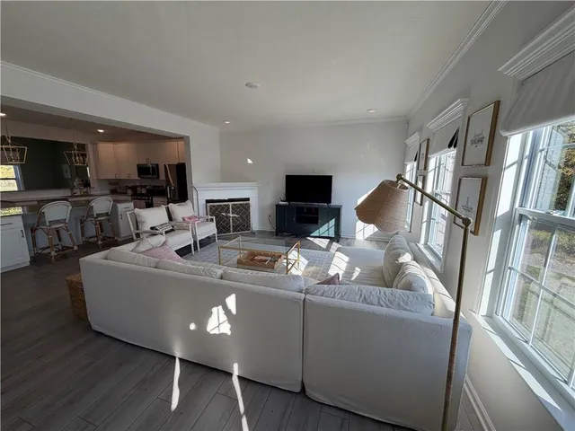 a living room with furniture fireplace and a flat screen tv