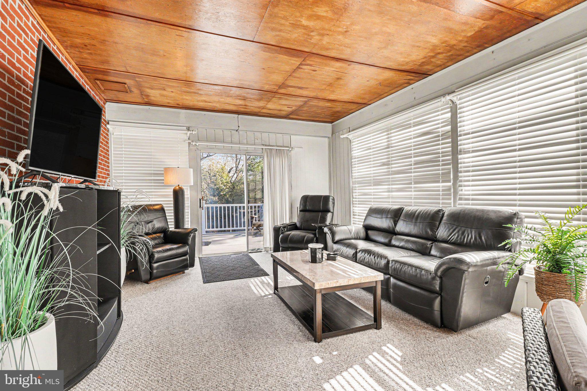 913 Stehman Road Millersville, PA 17551 - Photo 17 of 38 a living room with furniture flat screen tv and a large window