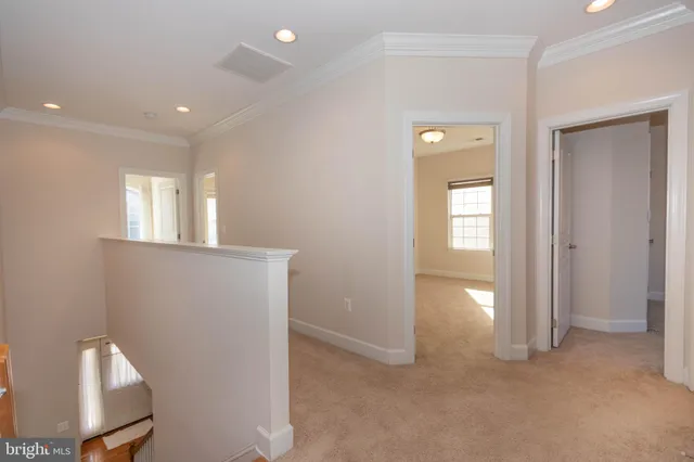 a view of an empty room with a ceiling fan