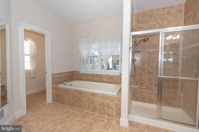 a bathroom with a granite countertop double vanity sink and a mirror