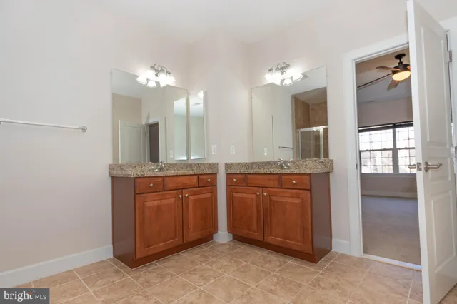 a spacious bathroom with a granite countertop tub sink and mirror
