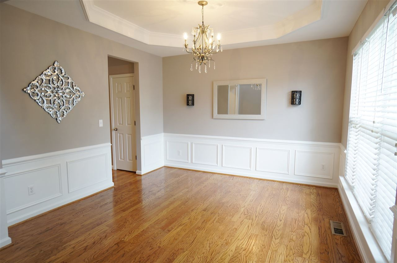 7730 San Gabriel Street Raleigh, NC 27613 - Photo 2 of 25 Dining room showcases stunning hardwood floors, brilliant wainscoting, tray ceiling & a beautiful backdrop for any mea Dining Room