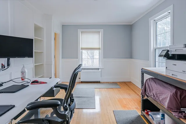 a bedroom with furniture and a flat screen tv