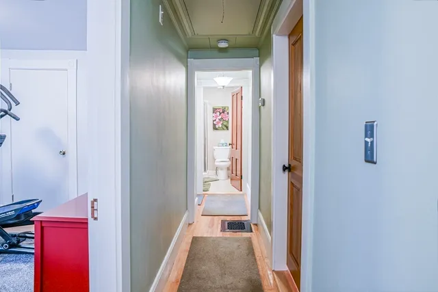 a view of a hallway with wooden floor and entryway
