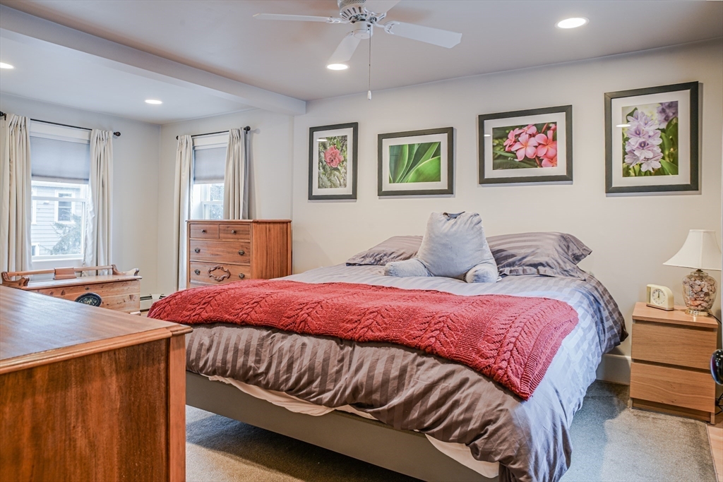 42 Bisson Street Beverly, MA 01915 - Photo 15 of 28 a bedroom with a bed and a chandelier