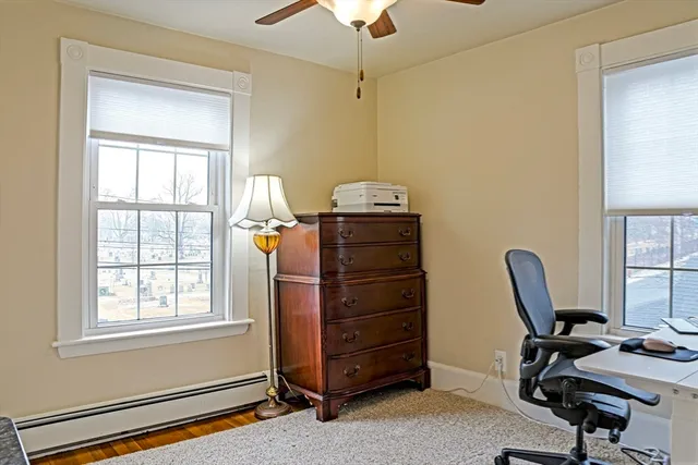 a view of a workspace with furniture and a window