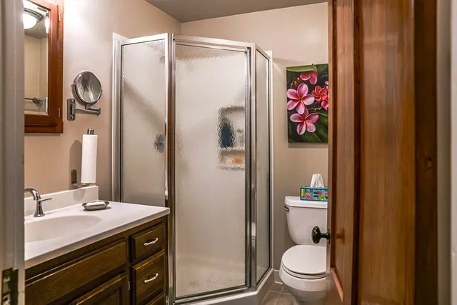 a bathroom with a granite countertop sink toilet and shower