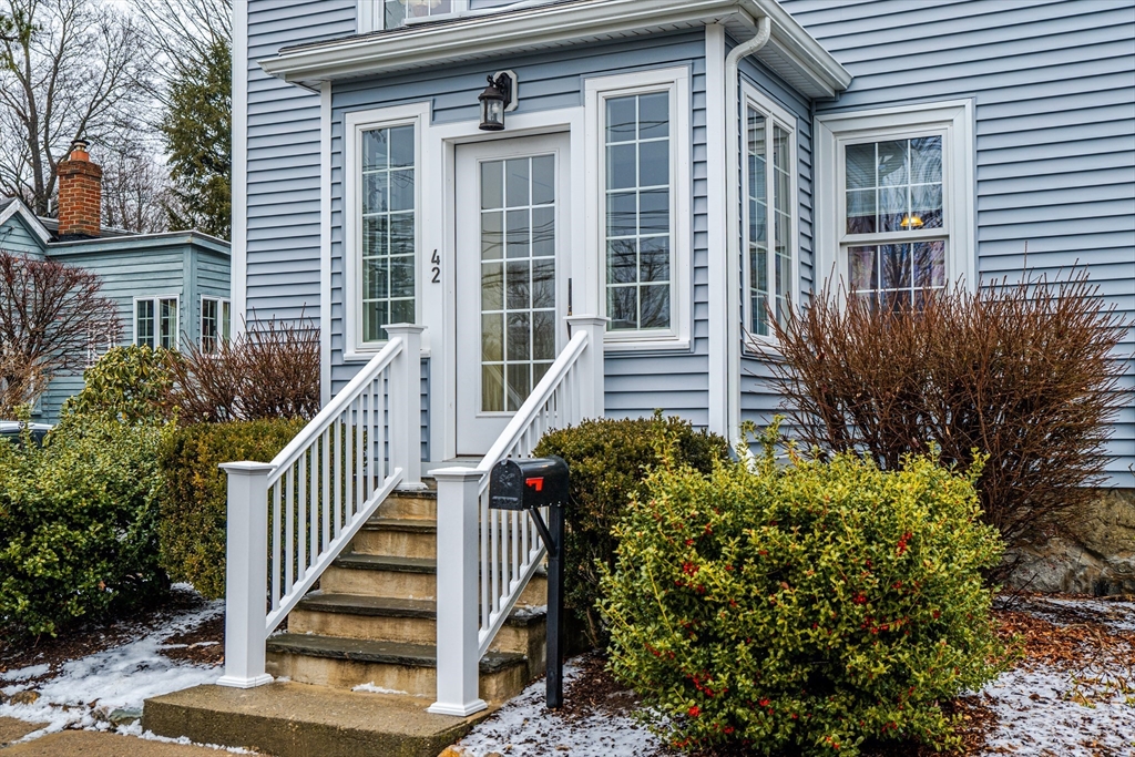 42 Bisson Street Beverly, MA 01915 - Photo 2 of 28 a view of a house with wooden fence and flower plants