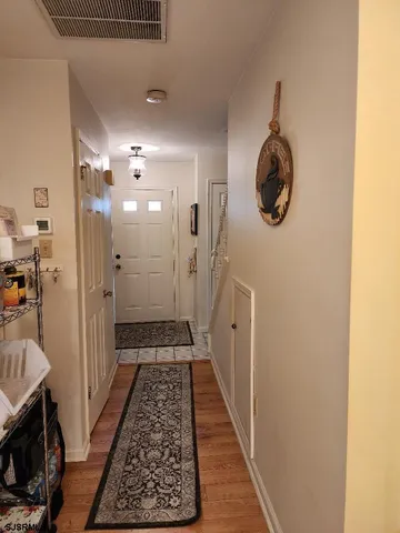 a view of a hallway with wooden floor