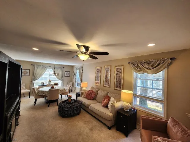 a living room with furniture fireplace and a large window