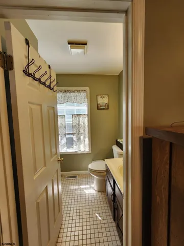 a bathroom with a sink a toilet and a shower