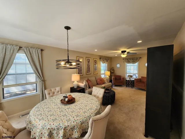 a living room with furniture a window and kitchen view