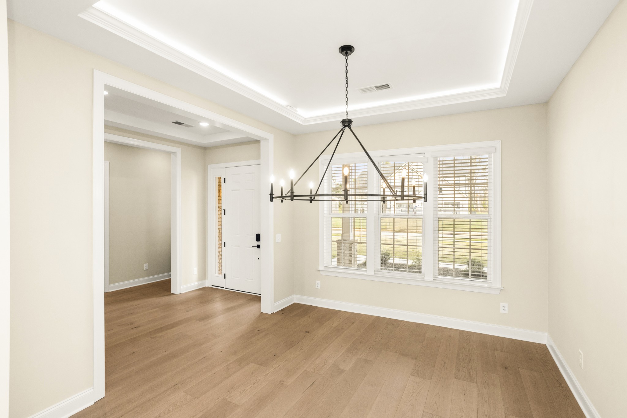 1935 Harmony Road Spring Hill, TN 37174 - Photo 13 of 60 a view of an empty room with wooden floor and windows