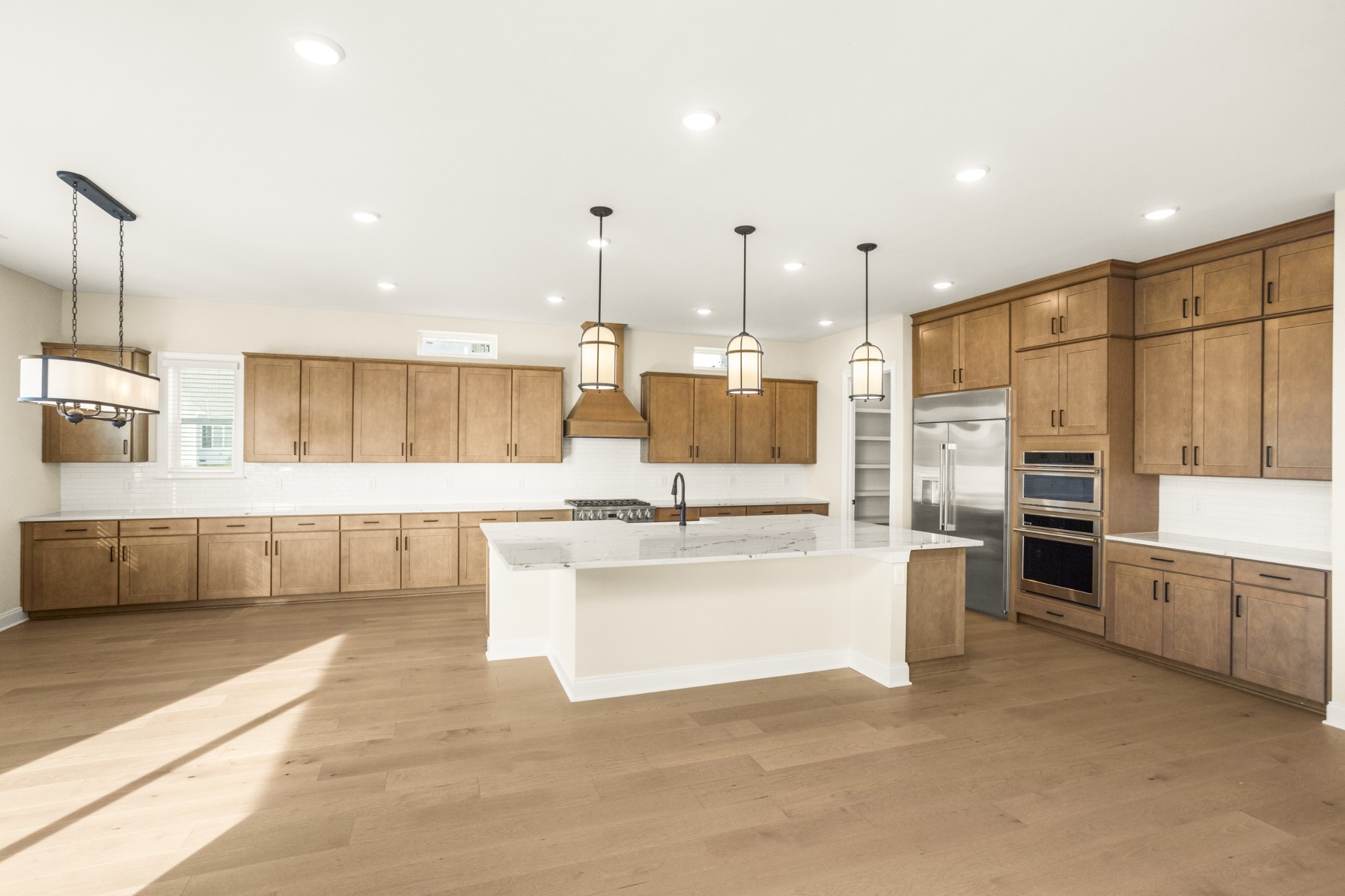 1935 Harmony Road Spring Hill, TN 37174 - Photo 19 of 60 a view of kitchen with stainless steel appliances kitchen island granite countertop a sink and cabinets