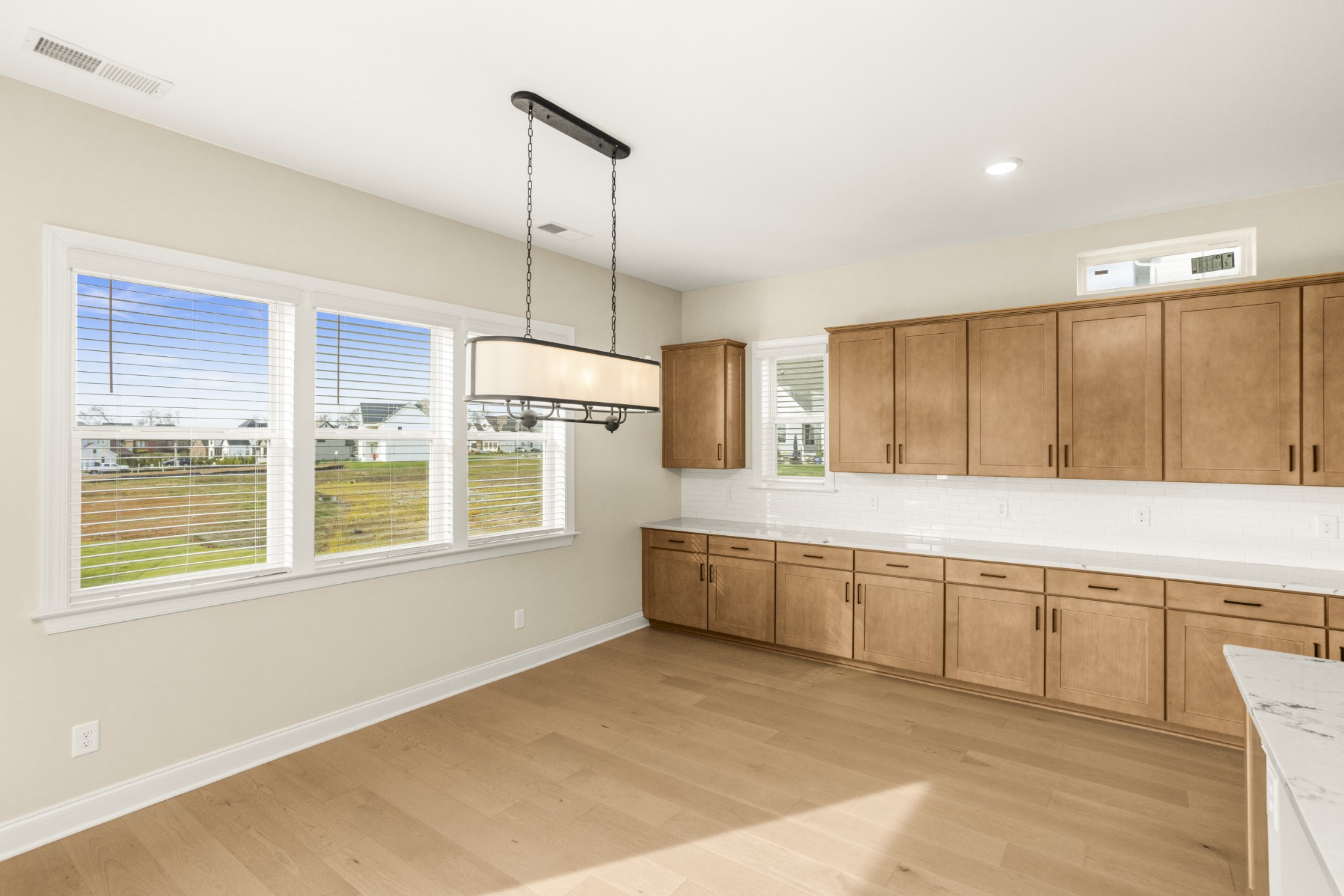 1935 Harmony Road Spring Hill, TN 37174 - Photo 22 of 60 a large kitchen with kitchen island a large window appliances and cabinets