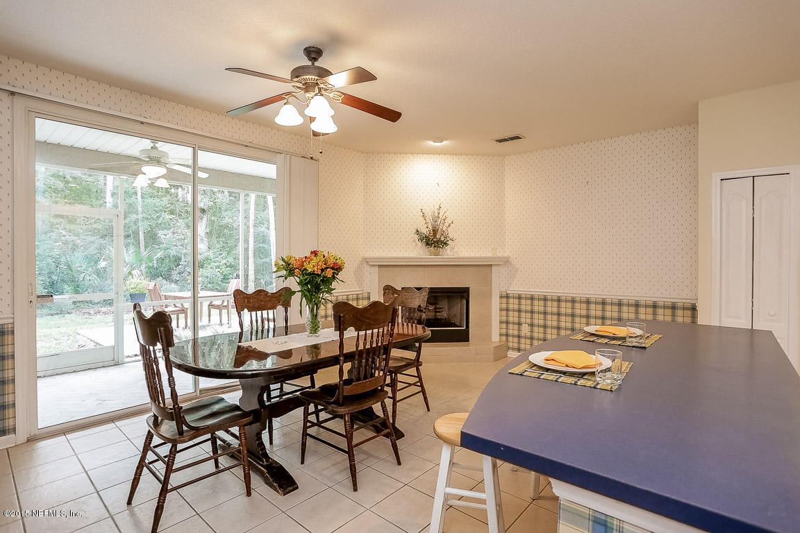816 Mill Stream Road Ponte Vedra Beach, FL 32082 - Photo 5 of 20 a dining room with furniture a fireplace and wooden floor