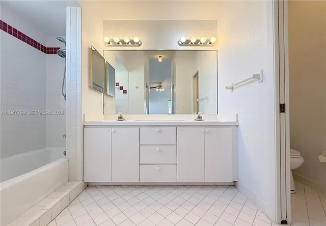 a spacious bathroom with a mirror a sink and bathtub