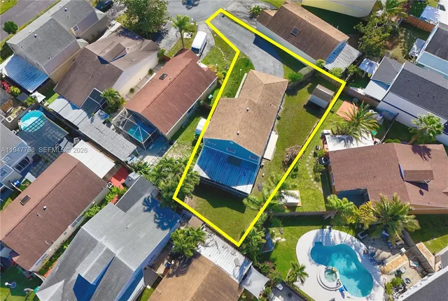 an aerial view of a house with a garden and plants