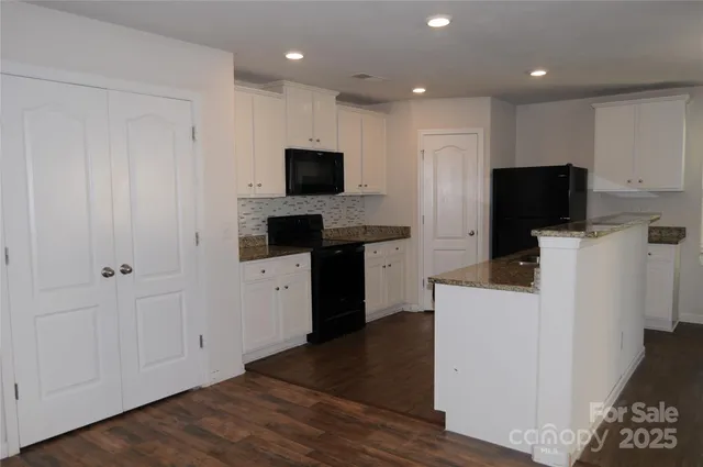 a kitchen with stainless steel appliances a refrigerator sink and microwave