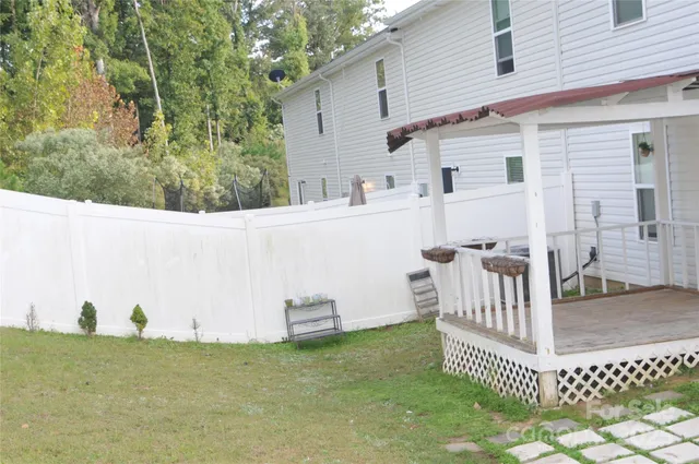 a view of a white house and a yard