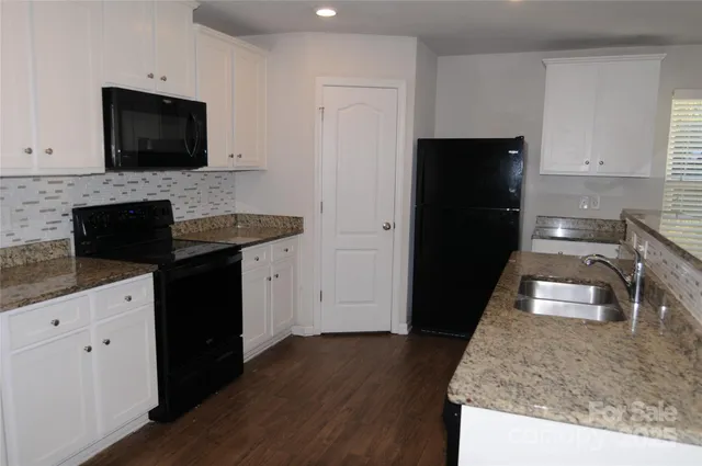 a kitchen with granite countertop wooden cabinets and a stainless steel appliances