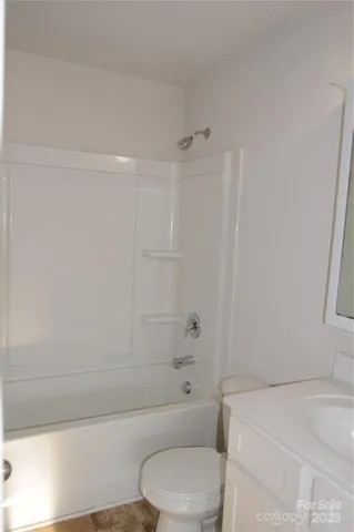 a bathroom with a toilet and a bath tub