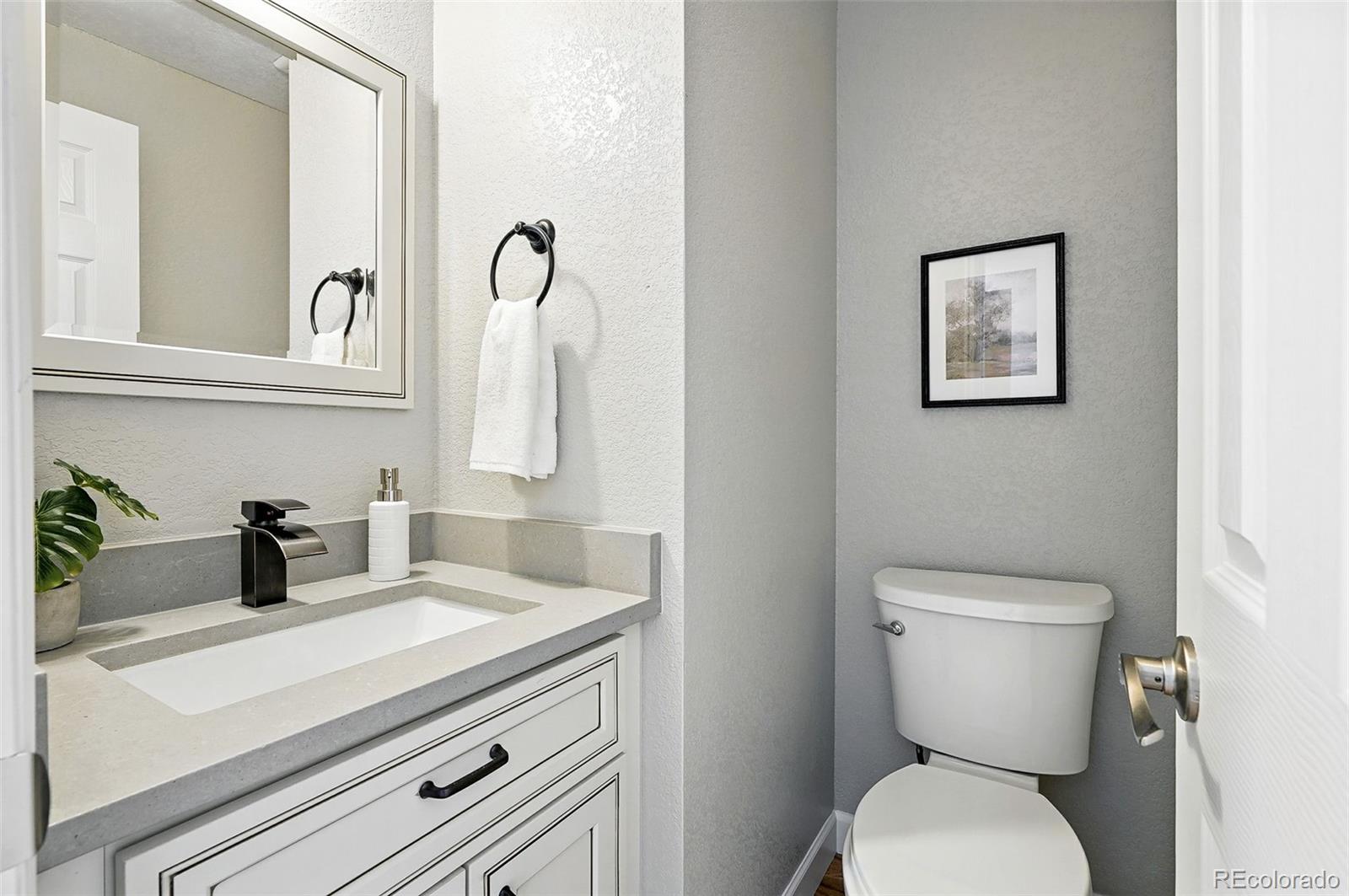 10320 West 35th Avenue Wheat Ridge, CO 80033 - Photo 15 of 46 a bathroom with a toilet sink and mirror