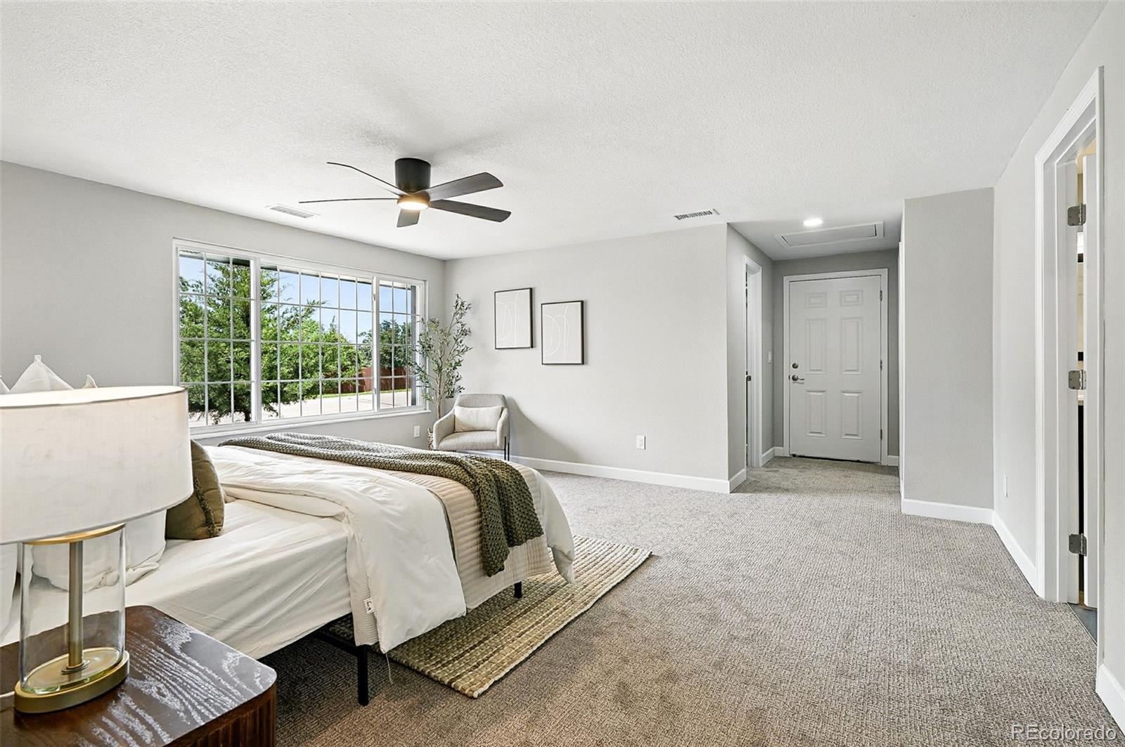 10320 West 35th Avenue Wheat Ridge, CO 80033 - Photo 16 of 46 a spacious bedroom with a bed and a window