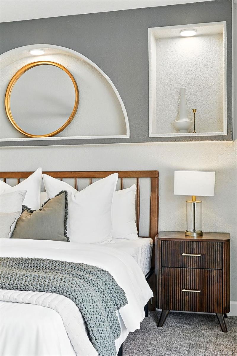 10320 West 35th Avenue Wheat Ridge, CO 80033 - Photo 18 of 46 a bedroom with a bed a mirror and lamp