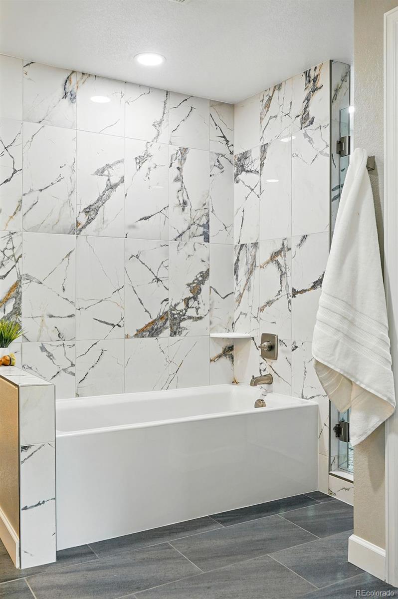 10320 West 35th Avenue Wheat Ridge, CO 80033 - Photo 20 of 46 a bathroom with a bathtub and shower