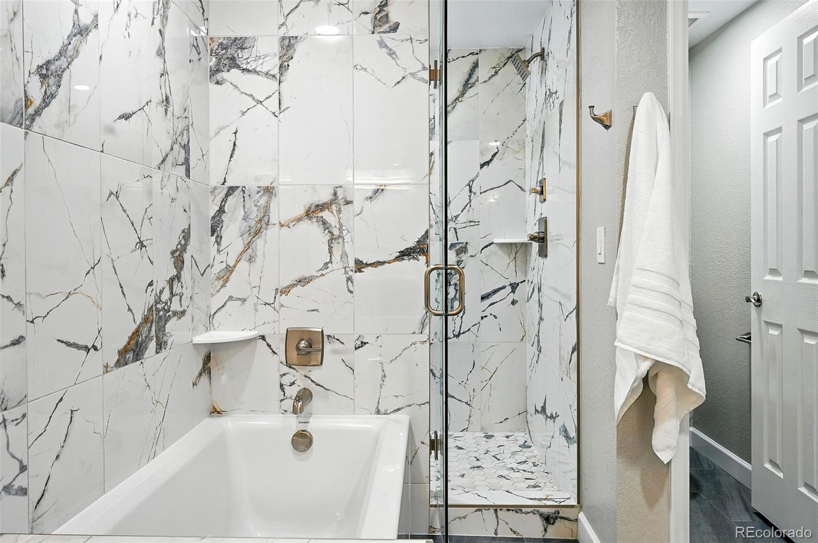 10320 West 35th Avenue Wheat Ridge, CO 80033 - Photo 21 of 46 a bathroom with a bathtub and shower