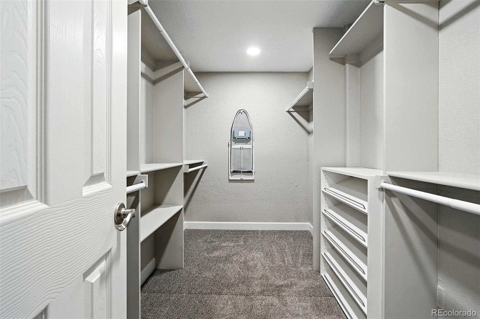 10320 West 35th Avenue Wheat Ridge, CO 80033 - Photo 23 of 46 a view of walk in closet with clothes and shoes