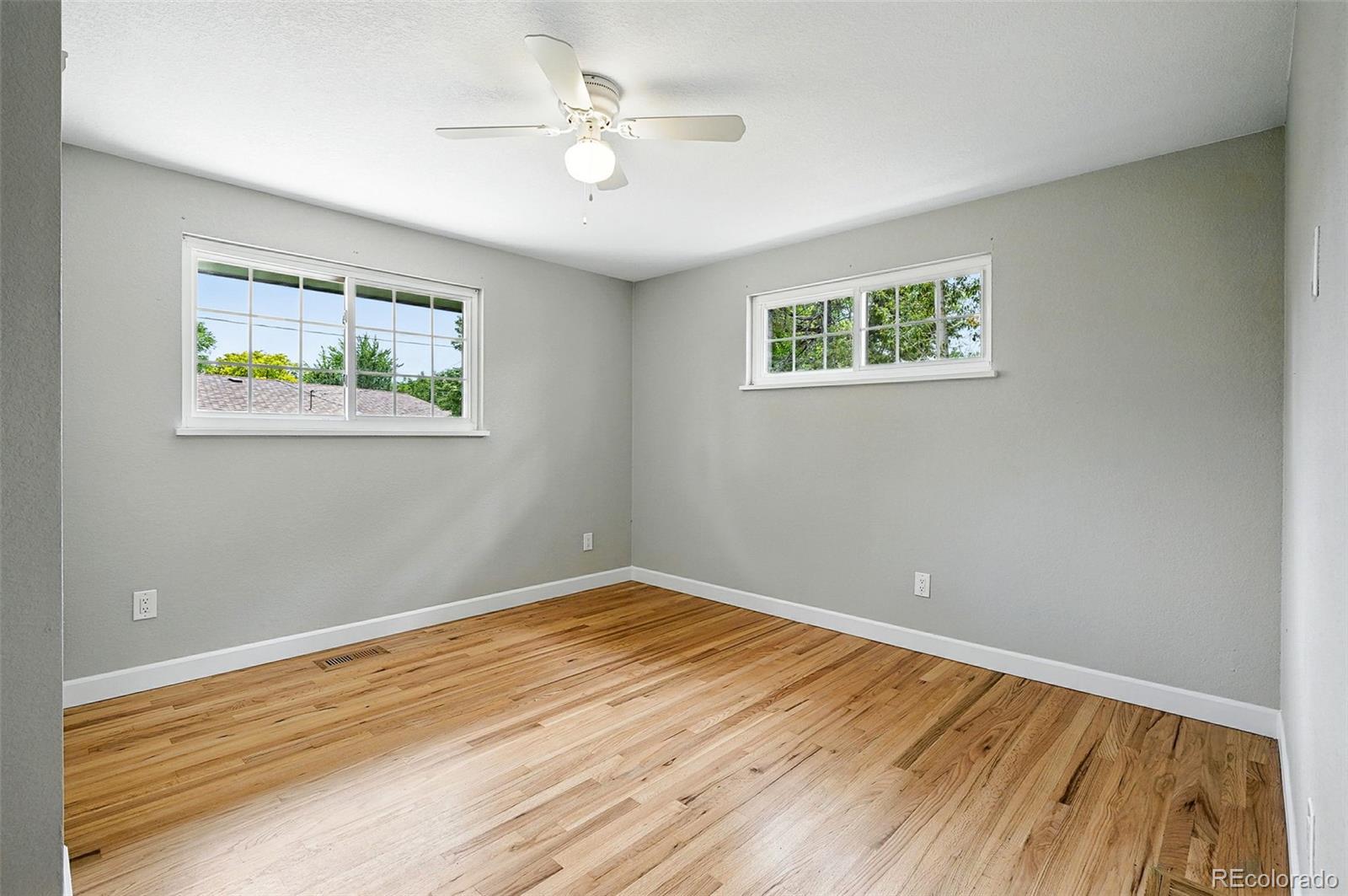 10320 West 35th Avenue Wheat Ridge, CO 80033 - Photo 25 of 46 a view of an empty room with wooden floor