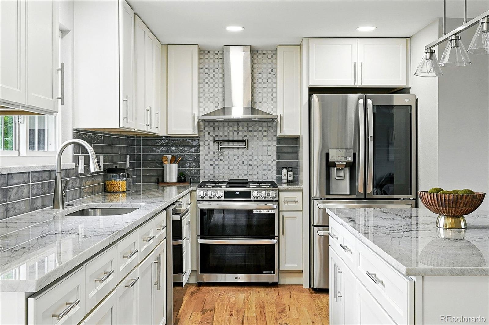 10320 West 35th Avenue Wheat Ridge, CO 80033 - Photo 9 of 46 a kitchen with stainless steel appliances granite countertop a sink stove and refrigerator