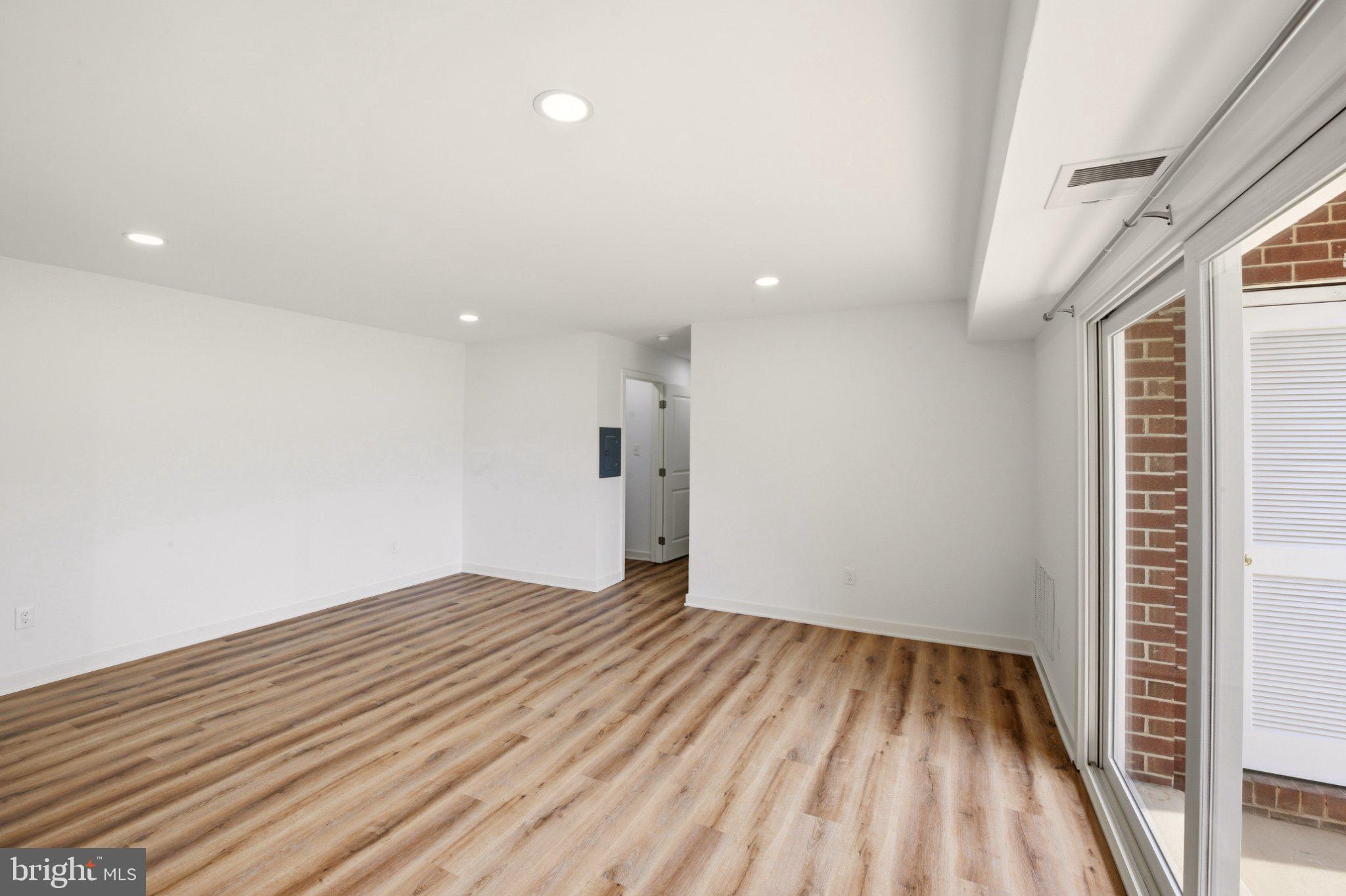 1207 Colony Court, Unit 122 Lebanon, PA 17042 - Photo 3 of 11 a view of an empty room with wooden floor and a window