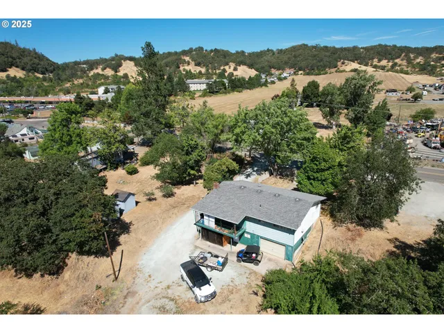 an aerial view of house with yard