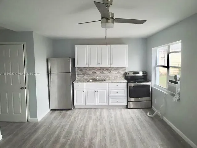 a kitchen with stainless steel appliances a refrigerator sink and cabinets