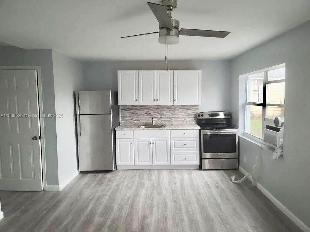 a kitchen with stainless steel appliances a refrigerator sink and cabinets