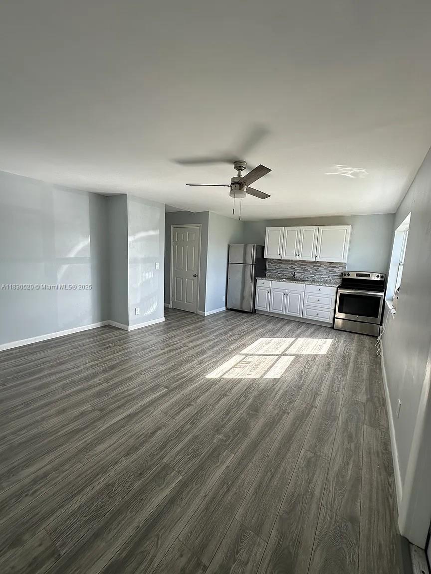 4410 26th Avenue, Unit 2 Vero Beach, FL 32967 - Photo 2 of 7 a view of a room with wooden floor and window