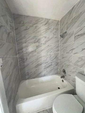 a bathroom with a bathtub and a toilet