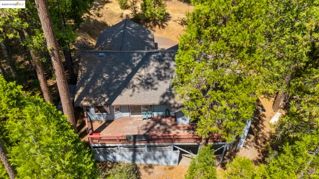 an aerial view of a house with a yard and lake view